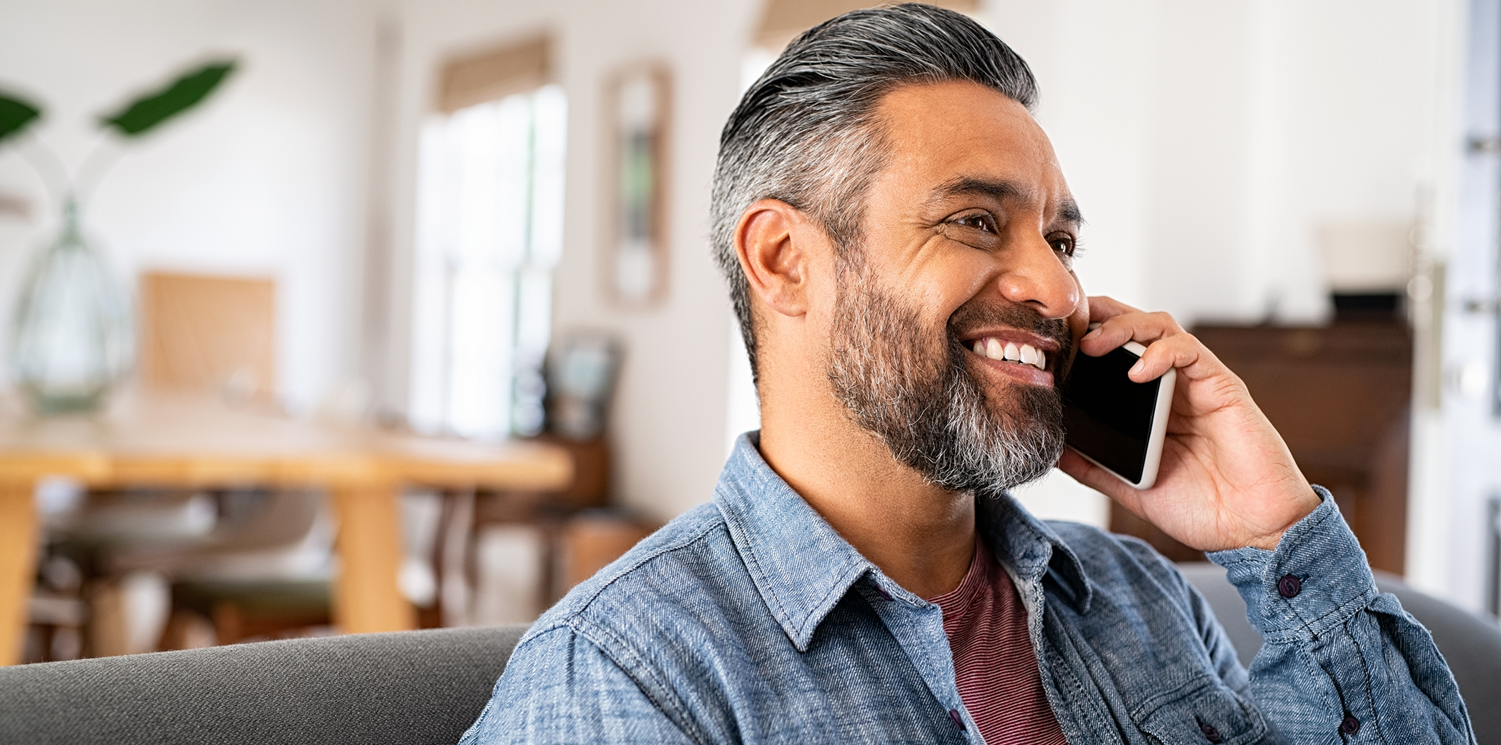 Man talking on the phone to request a virtual dental consultation in Bartlett