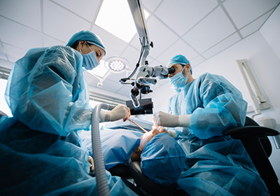 Dentist and assistant performing a tooth extraction on a patient